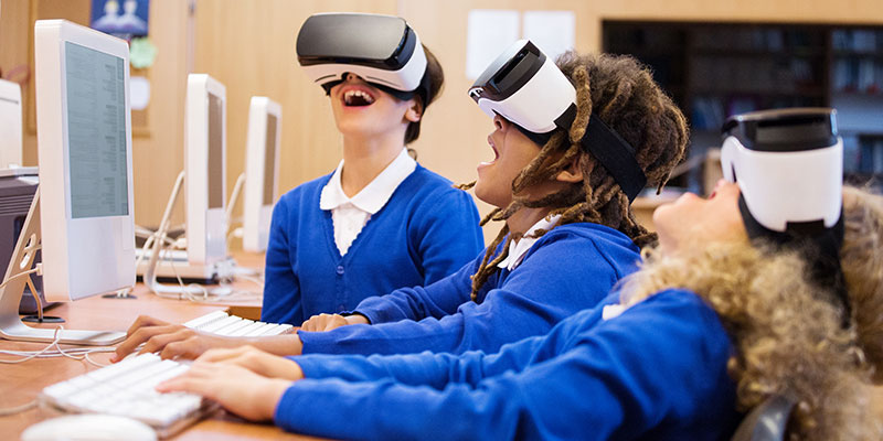 Kids playing with Virtual Reality machines in a computer lab