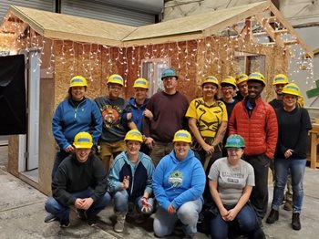 Pre-Apprenticeship students in front of the tiny house they built.