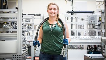 Girl with hydraulics hoses over her shoulders
